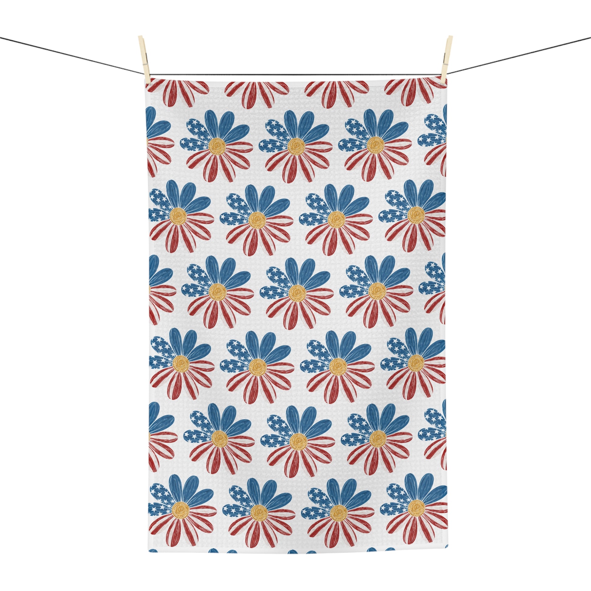 Microfiber tea towel with a patriotic red, white, and blue daisy pattern, hanging on a clothesline.