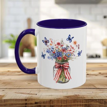 White ceramic mug with purple interior and handle, featuring a watercolor mason jar bouquet with patriotic flowers and butterflies.