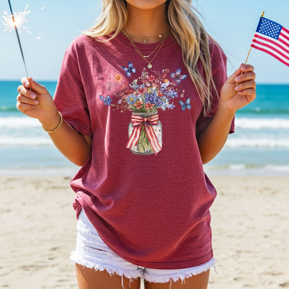 Red t-shirt with a watercolor mason jar of wildflowers, butterflies, and a patriotic ribbon.
