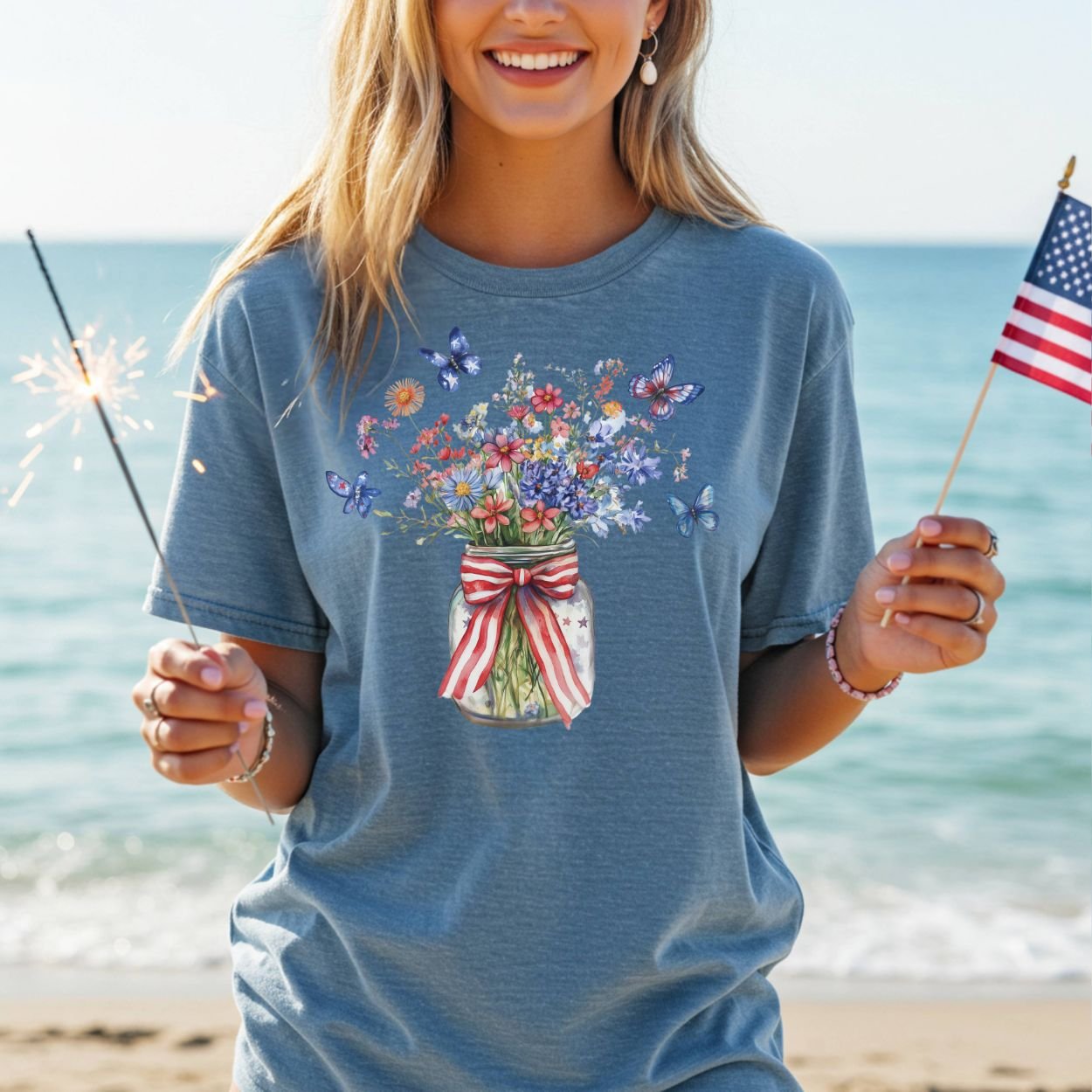 Garment-dyed blue t-shirt with a watercolor mason jar, wildflowers, butterflies, and a striped ribbon.