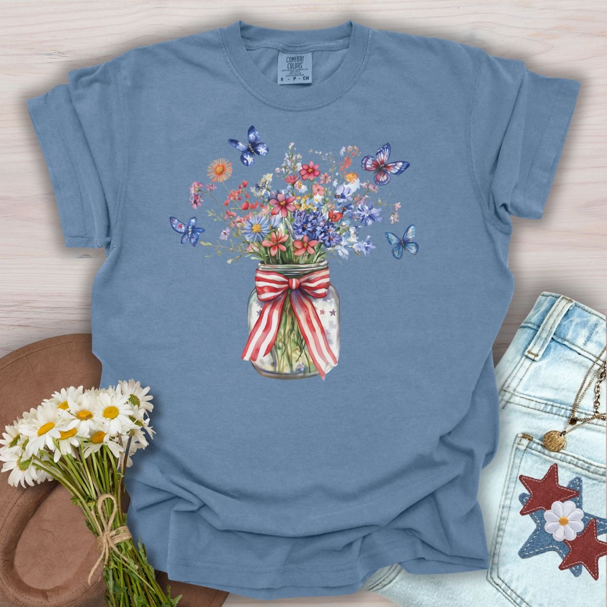 Blue Jean S t-shirt with a watercolor mason jar of wildflowers, patriotic ribbon, and butterflies.