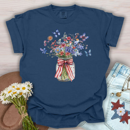 True Navy S t-shirt with watercolor wildflowers in a mason jar tied with a patriotic ribbon and butterflies.