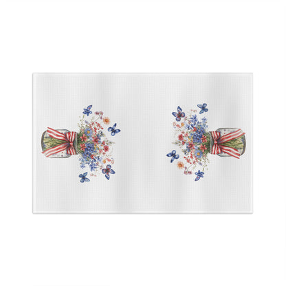 White microfiber tea towel with watercolor bouquets in mason jars tied with striped ribbons and blue butterflies.