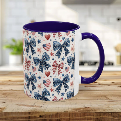 11oz ceramic mug with a blue handle and interior, featuring a patriotic bow, heart, and star pattern.