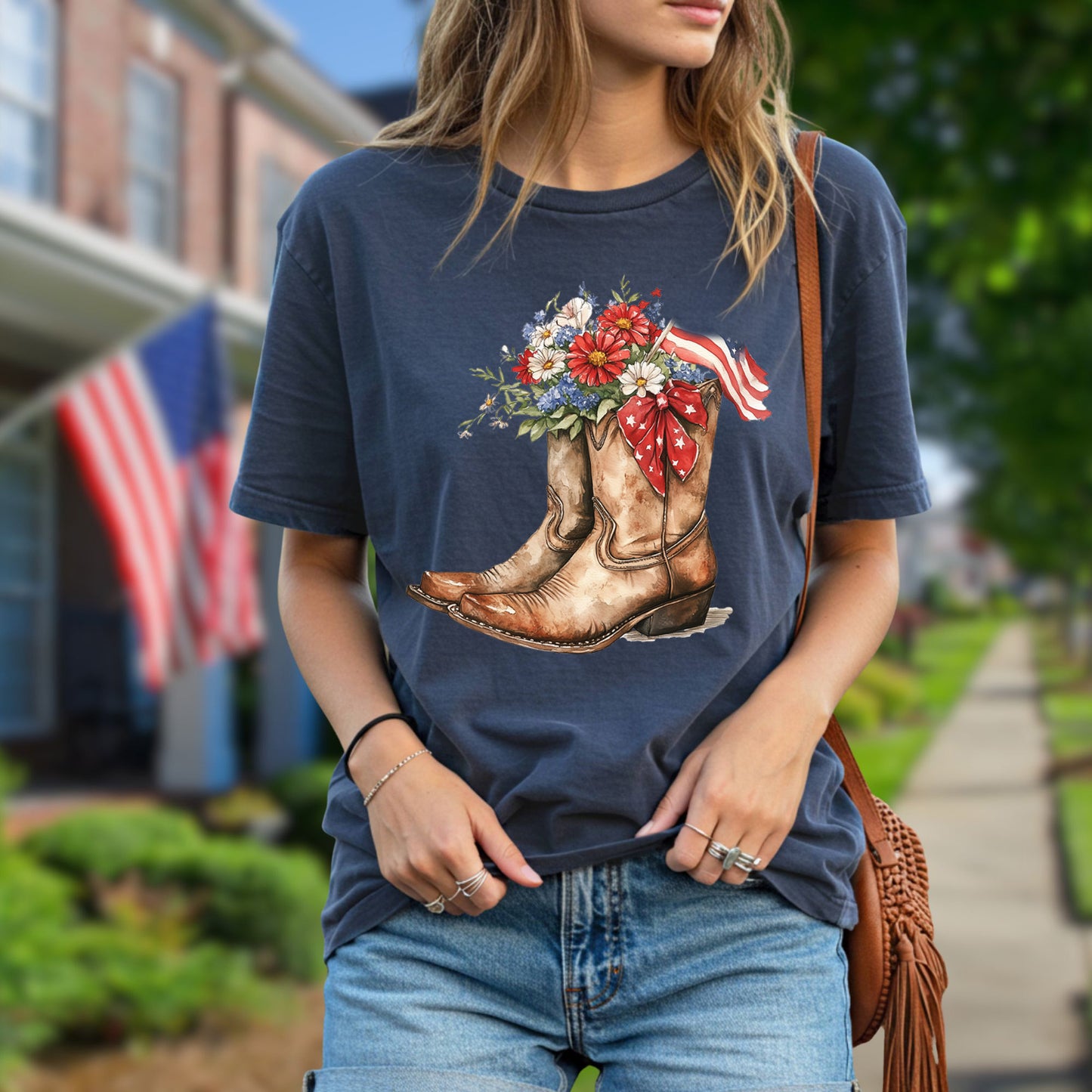 Navy t-shirt with watercolor cowboy boots, vibrant flowers, and an American flag.