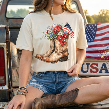 Garment-dyed t-shirt with watercolor cowboy boots, vibrant flowers, and an American flag.