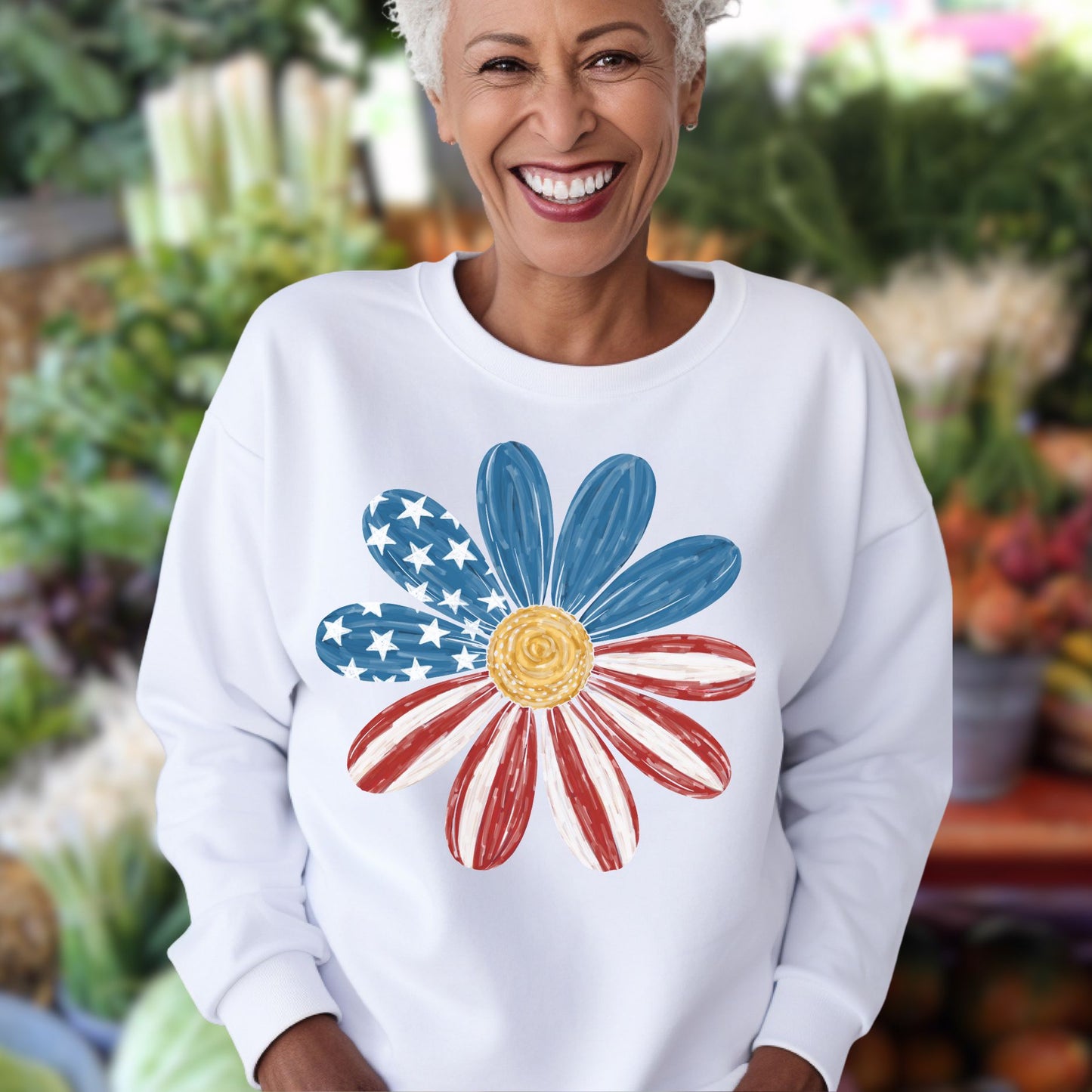 White crewneck sweatshirt with a hand-painted Americana daisy design, featuring blue star-speckled and red striped petals.