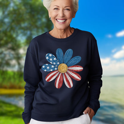 Woman wearing a navy crewneck sweatshirt with a hand-painted American flag daisy design.