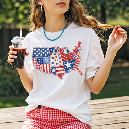White t-shirt with a faux patchwork map of America in patriotic red, white, and blue patterns.