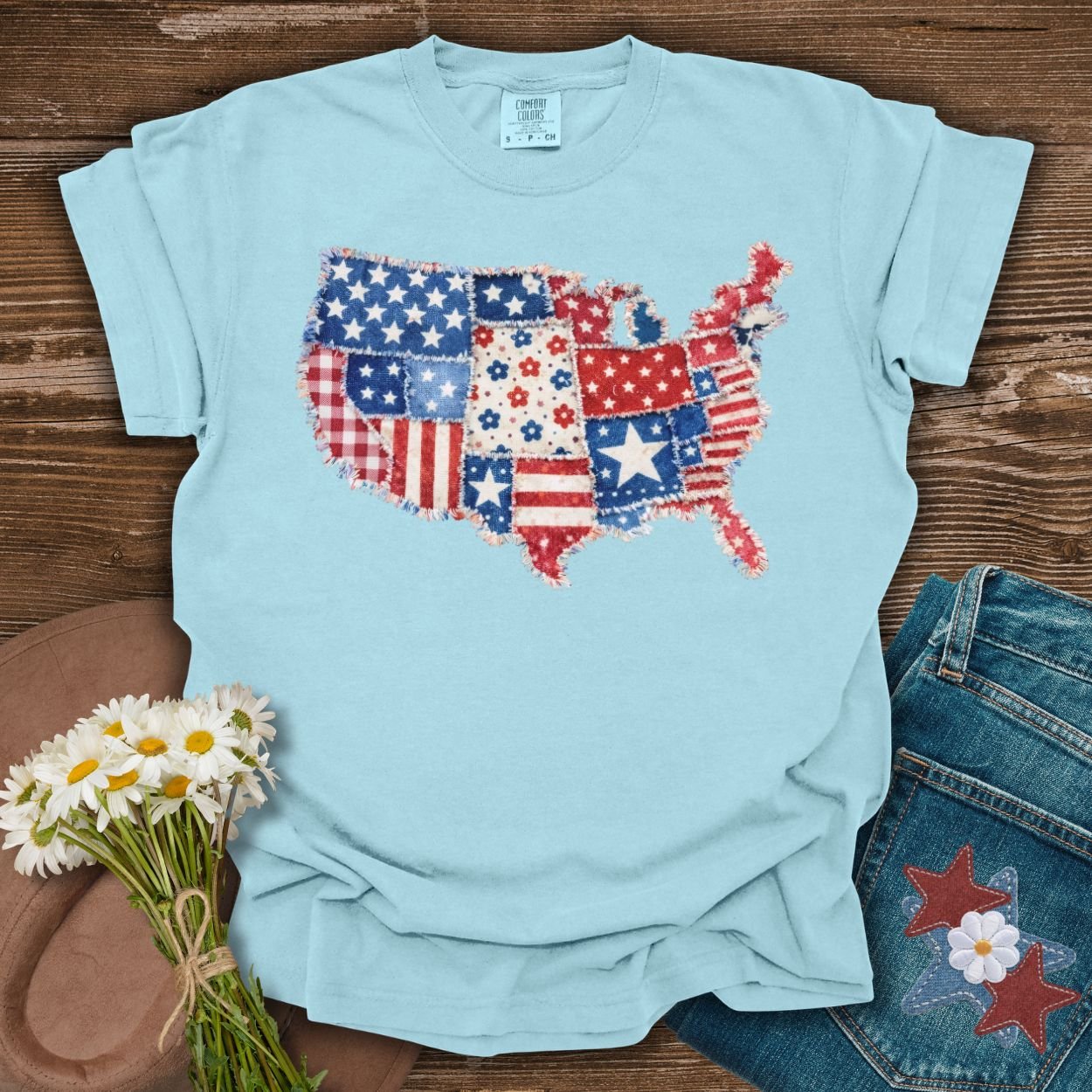 Chambray t-shirt with a printed faux patchwork map of America, featuring stars, stripes, and floral patterns.