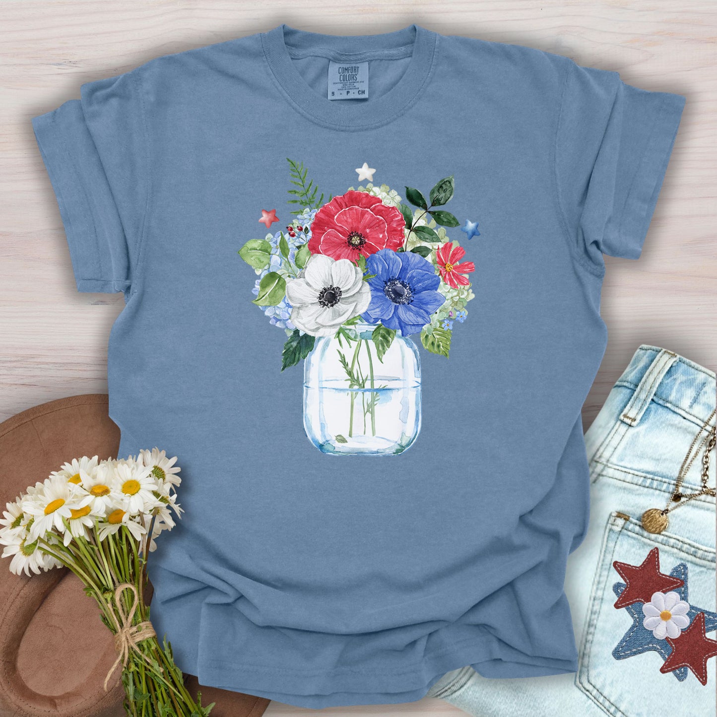 Blue Jean S t-shirt with a patriotic floral bouquet in a mason jar, featuring red, white, and blue anemones and stars.