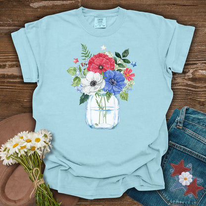 Chambray blue S t-shirt with a patriotic floral bouquet in a mason jar, featuring red, white, and blue anemones and stars.