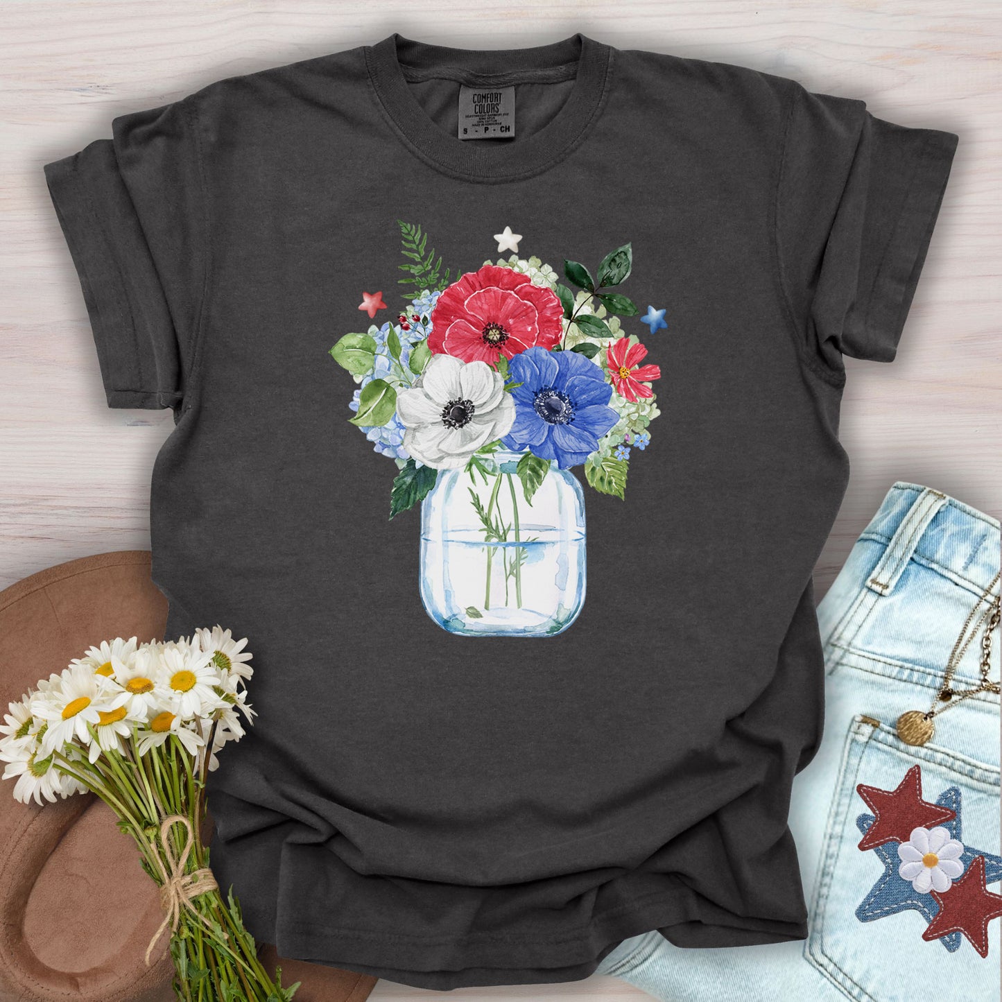 Pepper S t-shirt with a watercolor patriotic floral bouquet in a mason jar, featuring red, white, and blue anemones and stars.