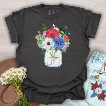 Pepper S t-shirt with a watercolor patriotic floral bouquet in a mason jar, featuring red, white, and blue anemones and stars.