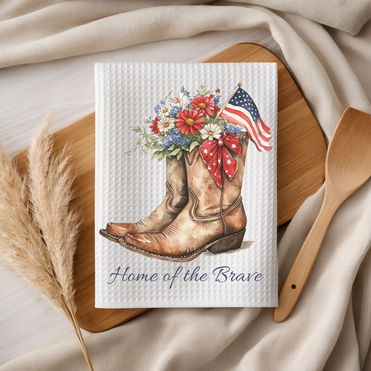 White microfiber tea towel with patriotic floral cowboy boots, American flag, and "Home of the Brave" text.