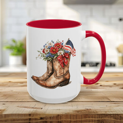 White 15oz ceramic mug with red handle and interior, featuring watercolor cowboy boots, wildflowers, and an American flag.