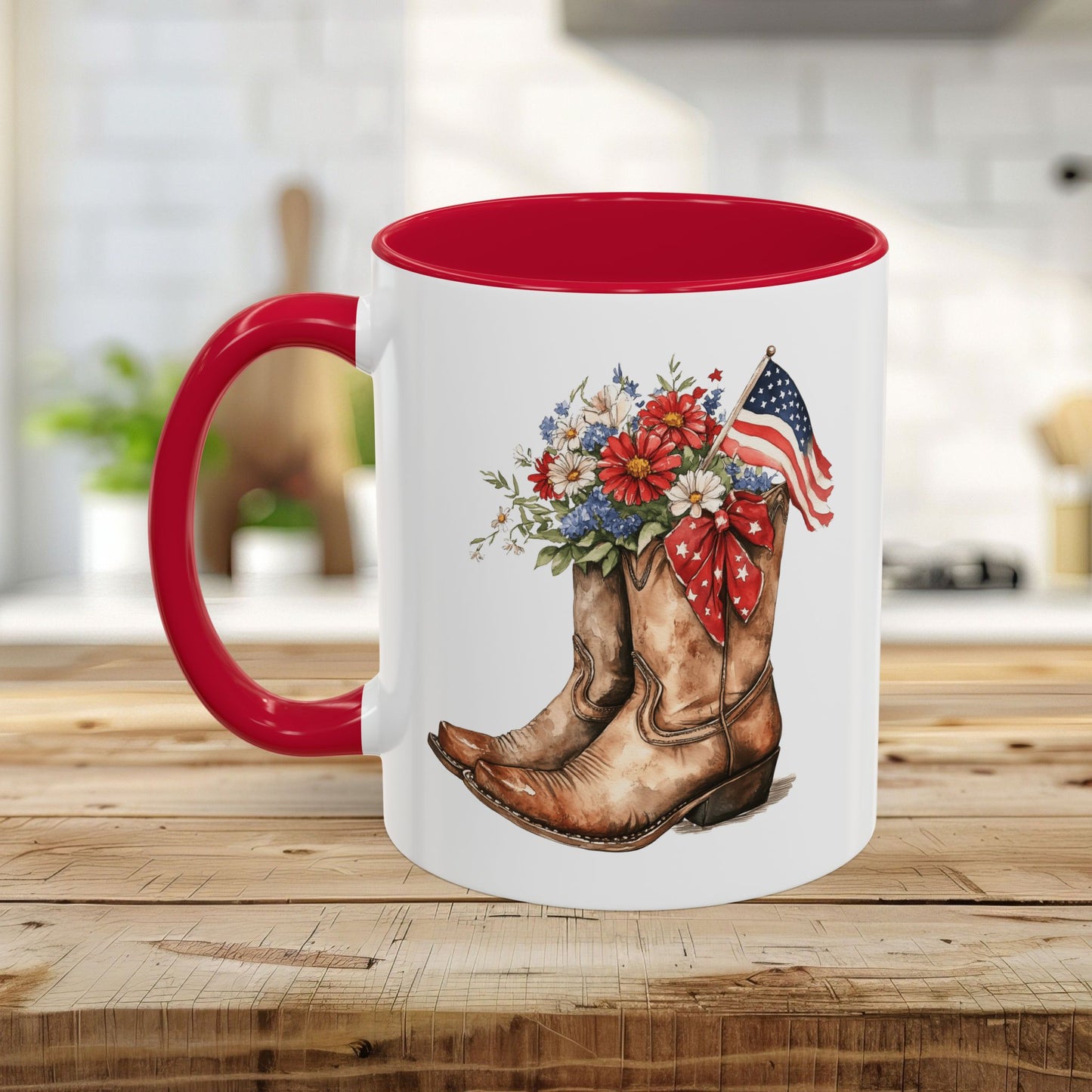 White ceramic mug with red handle and interior, featuring watercolor cowboy boots with wildflowers and an American flag.
