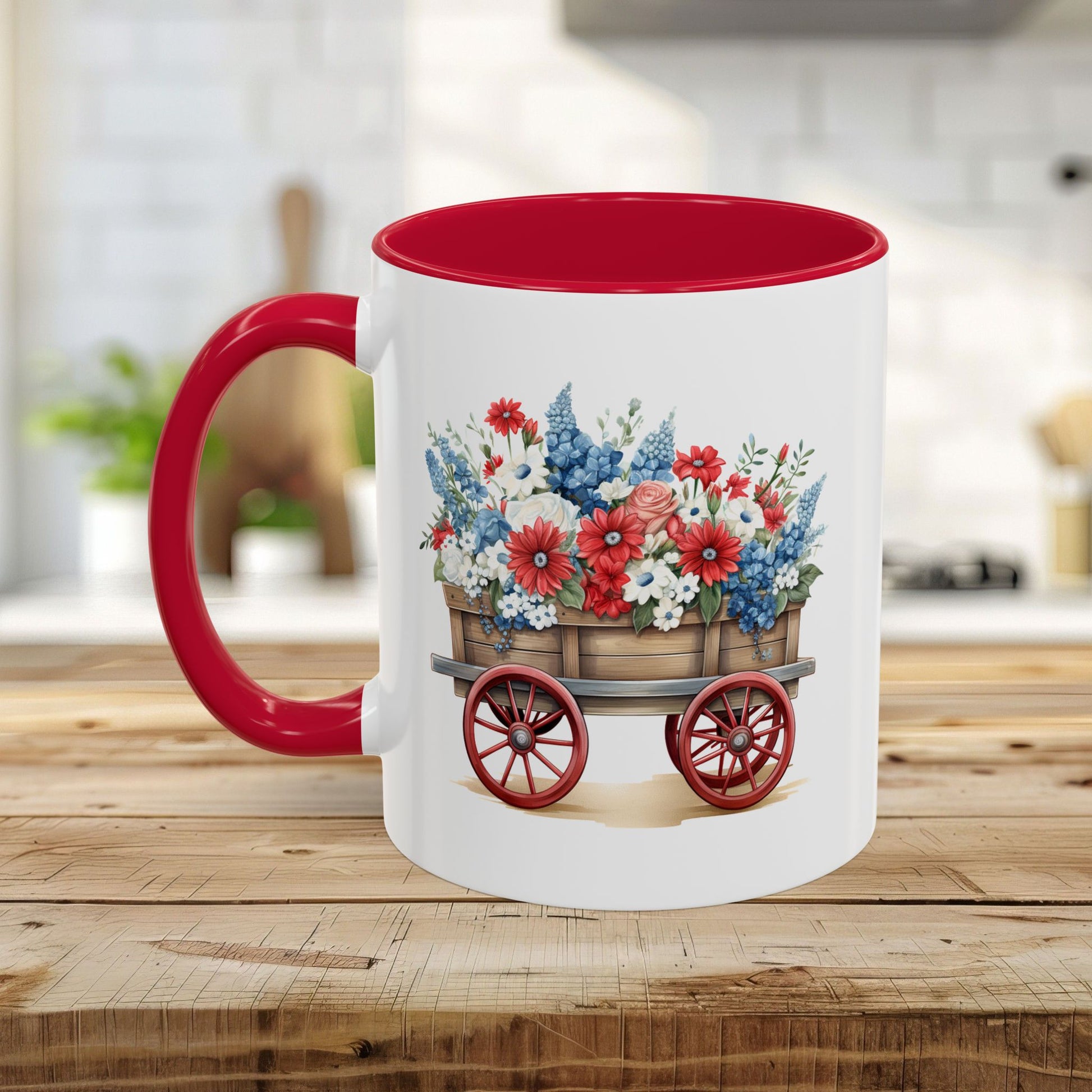 White ceramic mug with red handle and interior, featuring a vintage wagon overflowing with red, white, and blue florals.