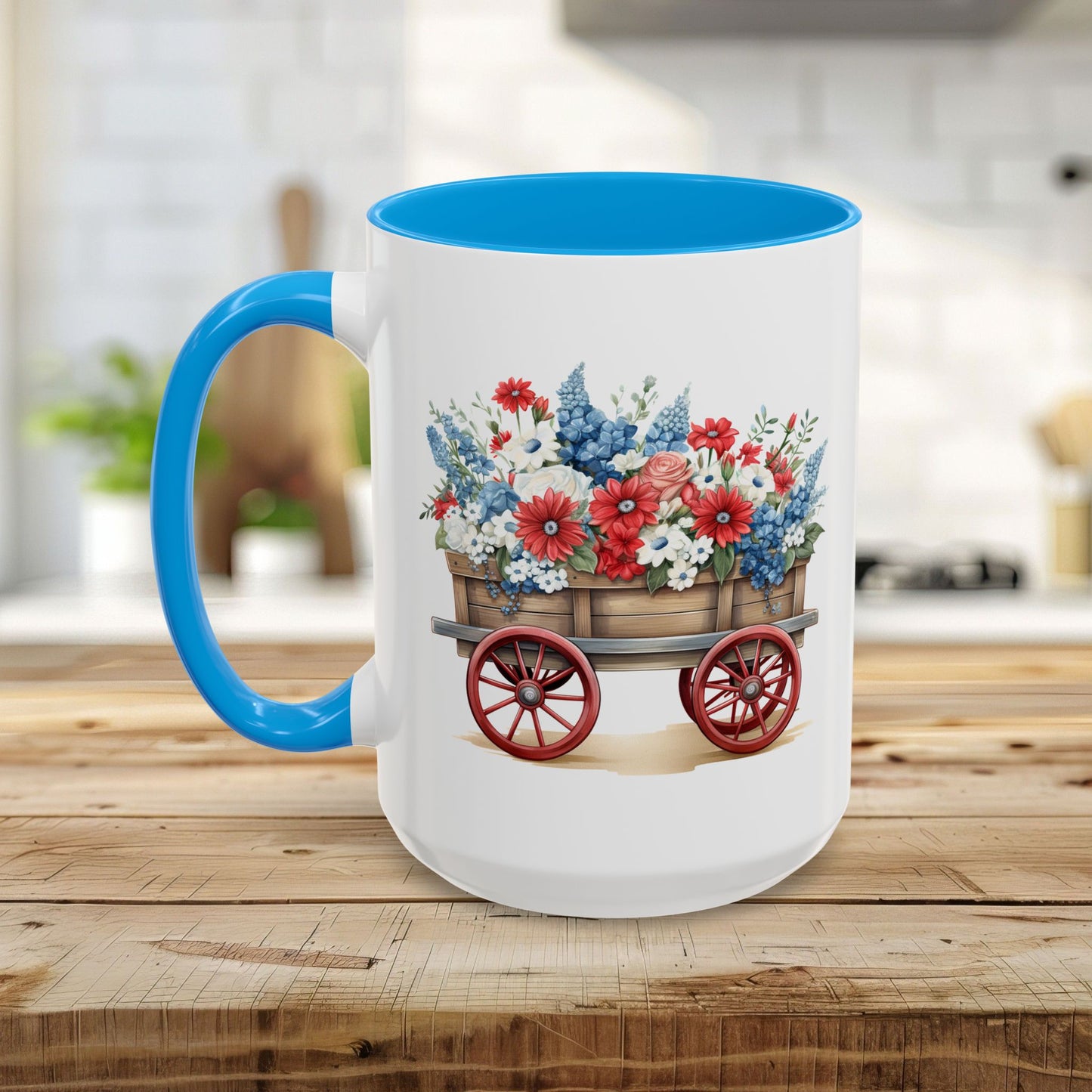 White ceramic mug with blue handle and interior, featuring a vintage wagon overflowing with red, white, and blue florals.