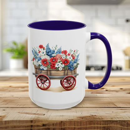 15oz ceramic mug with blue handle/interior, featuring a vintage wagon overflowing with red, white, and blue florals.