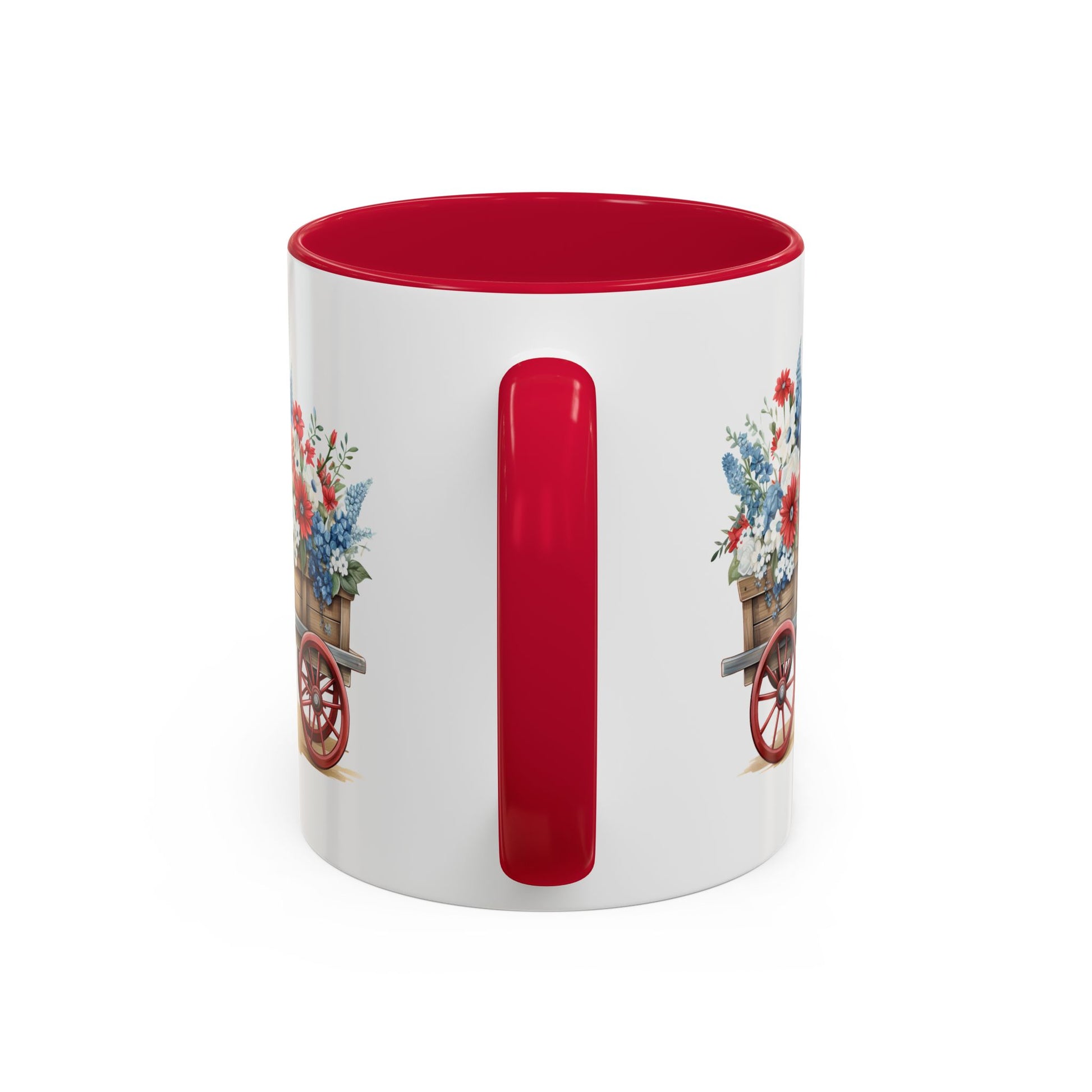 White ceramic mug with red handle and interior, featuring a vintage wagon with patriotic red, white, and blue florals.