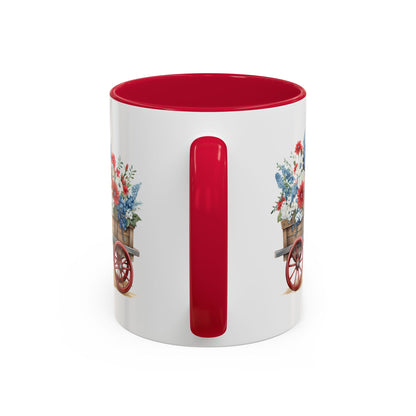 White ceramic mug with red handle and interior, featuring a vintage wagon with patriotic red, white, and blue florals.