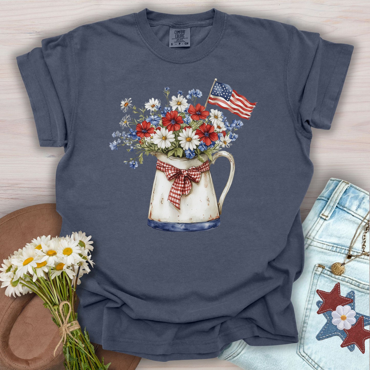 Denim S t-shirt with a vintage-style patriotic flower pitcher illustration, American flag, and gingham bow.
