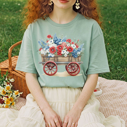 Relaxed-fit, garment-dyed sage green tee with a hand-painted wagon overflowing with red, white, and blue florals.