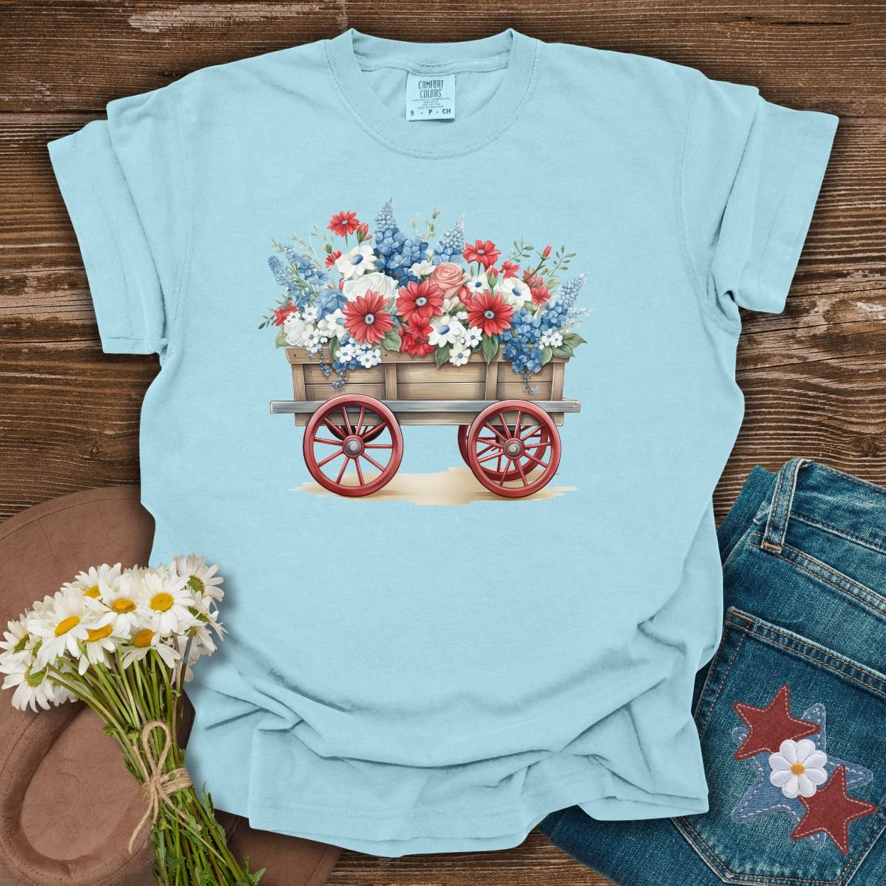Chambray blue cotton t-shirt with a patriotic red, white, and blue flower wagon design.