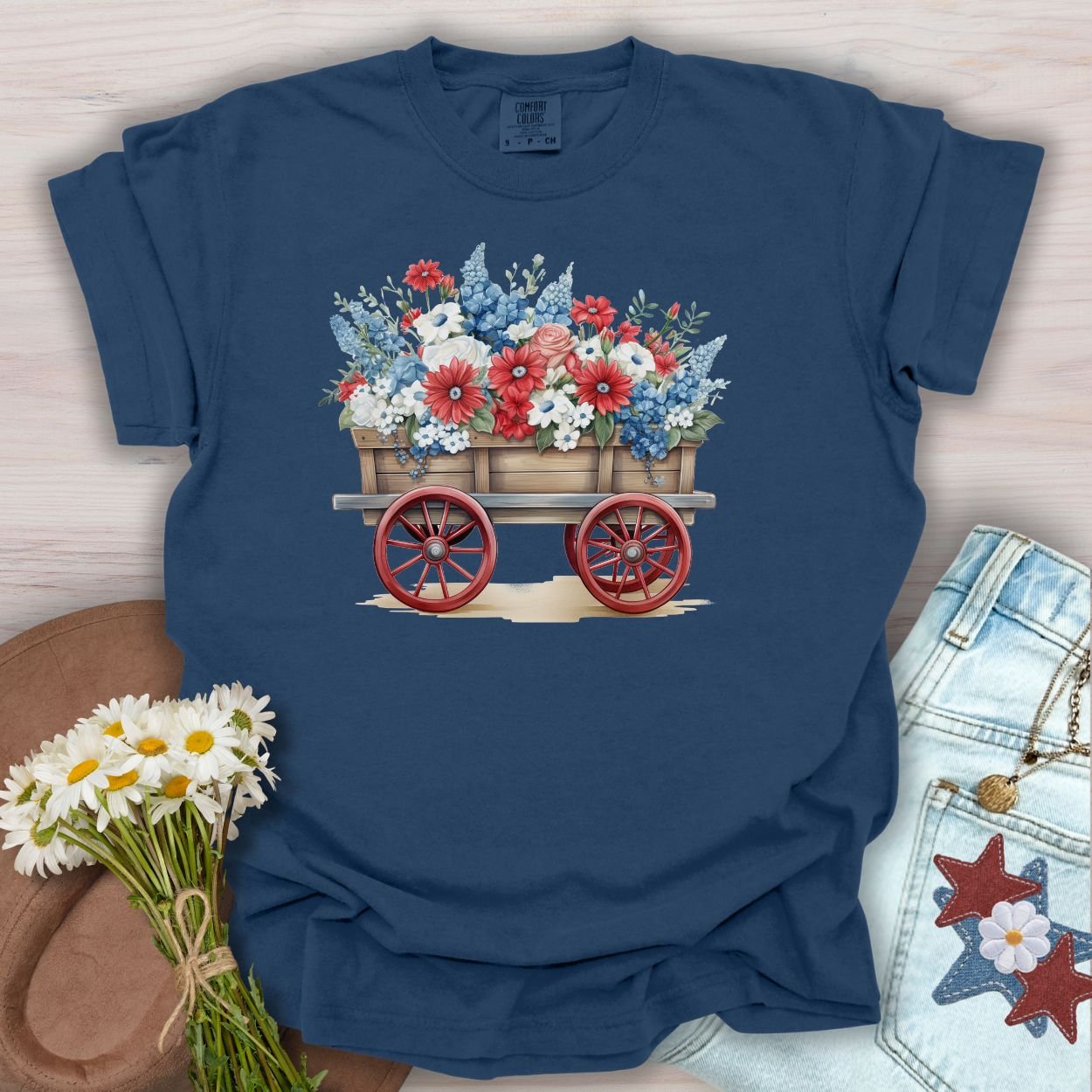 True Navy S t-shirt with a hand-painted wagon overflowing with red, white, and blue florals.