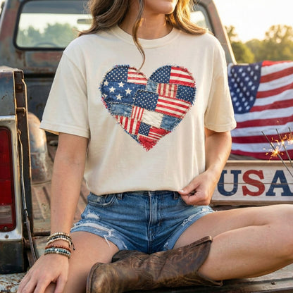 Patriotic heart faux quilt t-shirt with distressed American flag patches, worn by a woman in denim shorts.