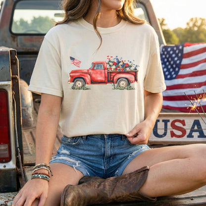 Garment-dyed cream t-shirt with a watercolor red pickup truck, wildflowers, and an American flag.