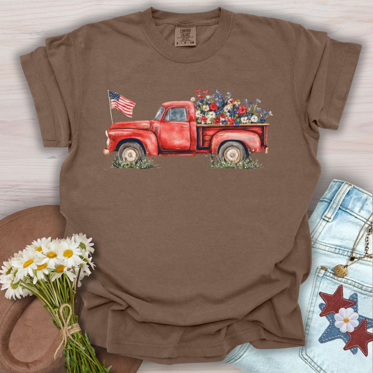Espresso t-shirt with a watercolor red pickup truck, wildflowers, and an American flag in the bed.