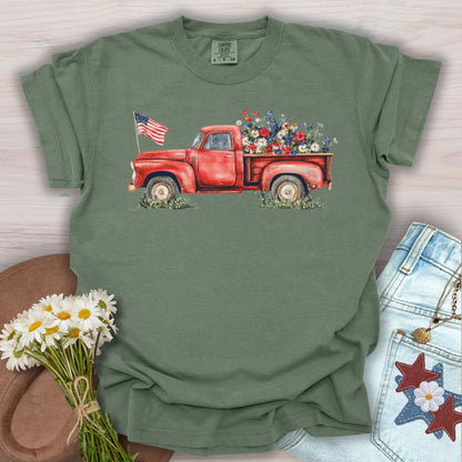 Moss green S-size t-shirt with a watercolor red pickup truck, wildflowers, and an American flag.