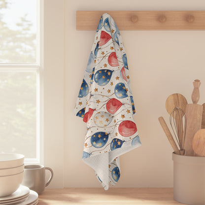 Patriotic microfiber tea towel with red, white, and blue balloons and golden stars, hanging on a wooden peg.