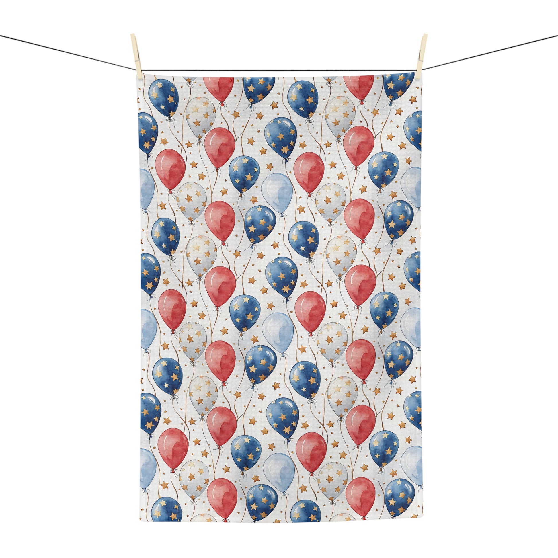 Microfiber tea towel with red, white, and blue balloons, and golden stars, hanging on a clothesline.