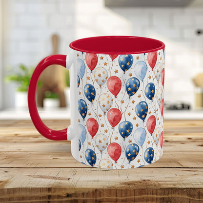 White ceramic mug with red interior and handle, featuring a watercolor red, white, and blue balloon print.