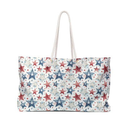 Spacious red, white, and blue star-patterned spun polyester weekender bag with cream rope handles.