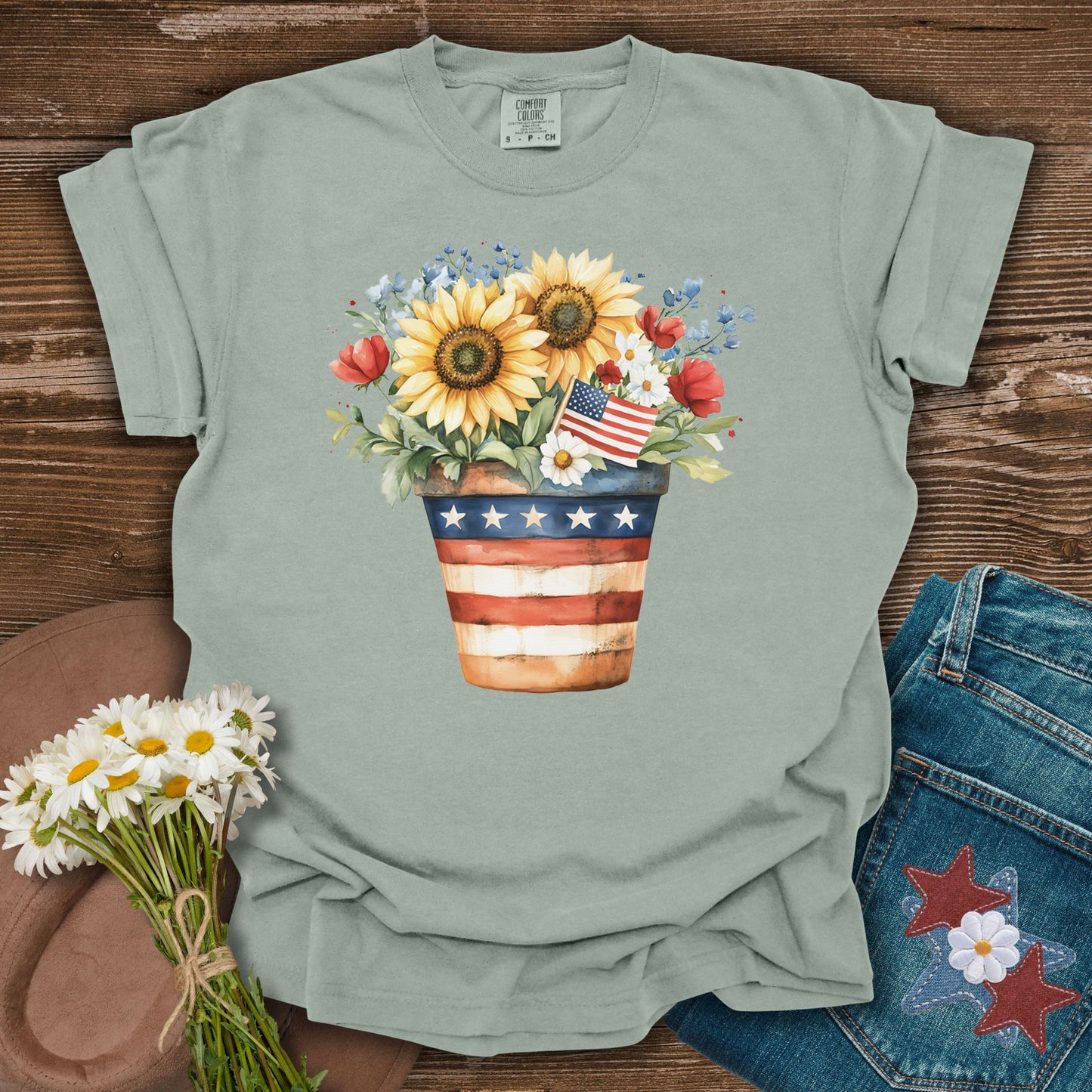 Bay S t-shirt with a patriotic sunflower bouquet in a flag-decorated pot.
