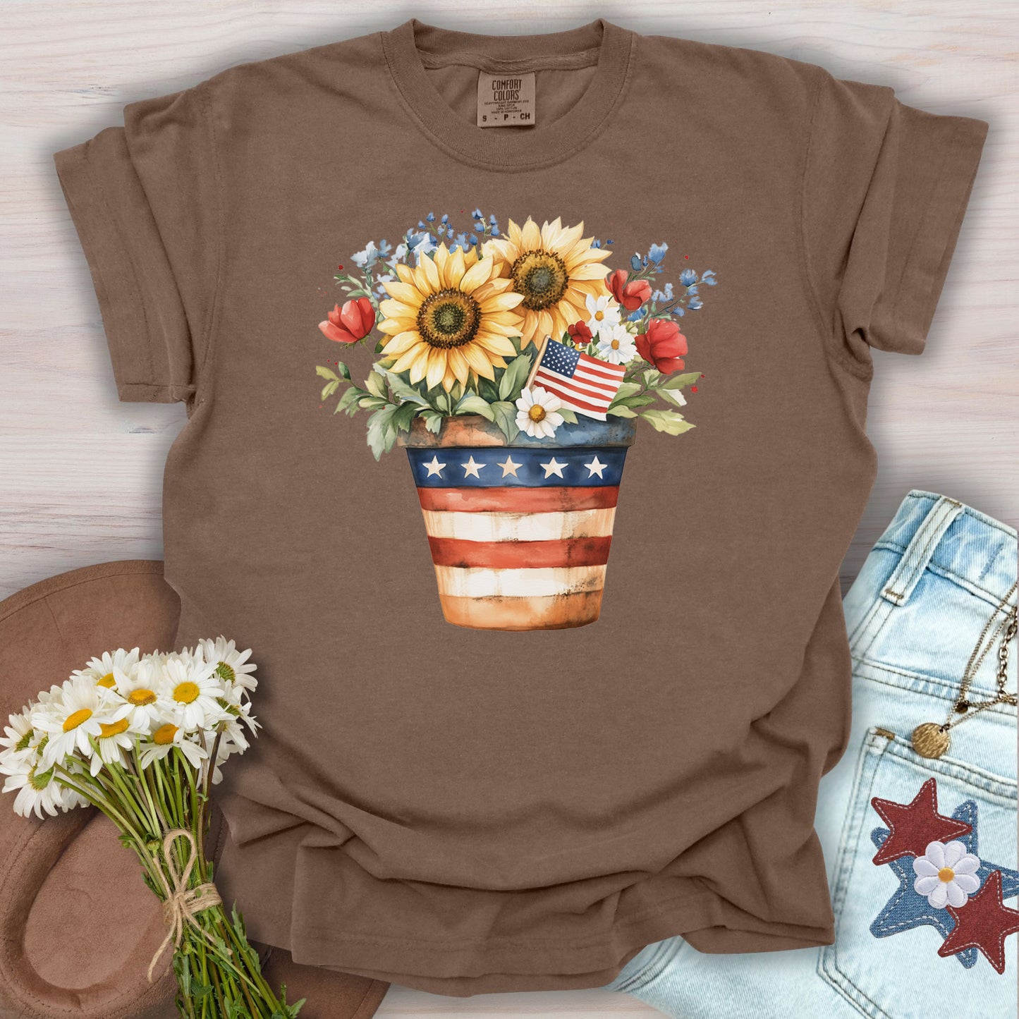 Espresso S t-shirt with a patriotic sunflower bouquet in an American flag pot, small US flag, and daisies.