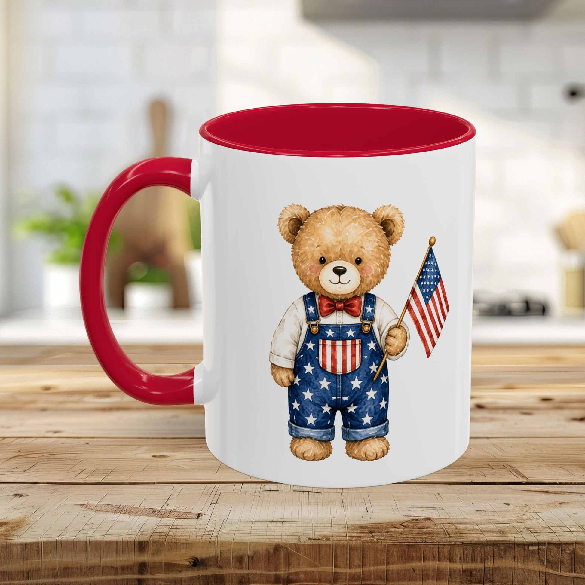 White ceramic mug with red interior and handle, featuring a watercolor teddy bear in star-spangled overalls holding a US flag.