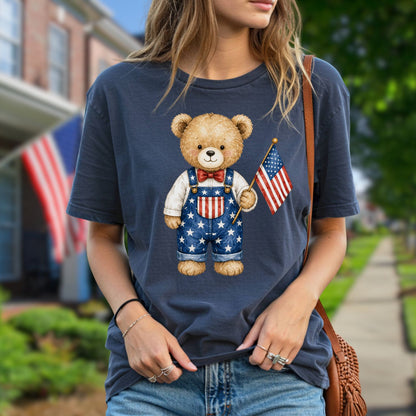 Navy blue t-shirt with a hand-drawn teddy bear in Americana overalls holding an American flag.