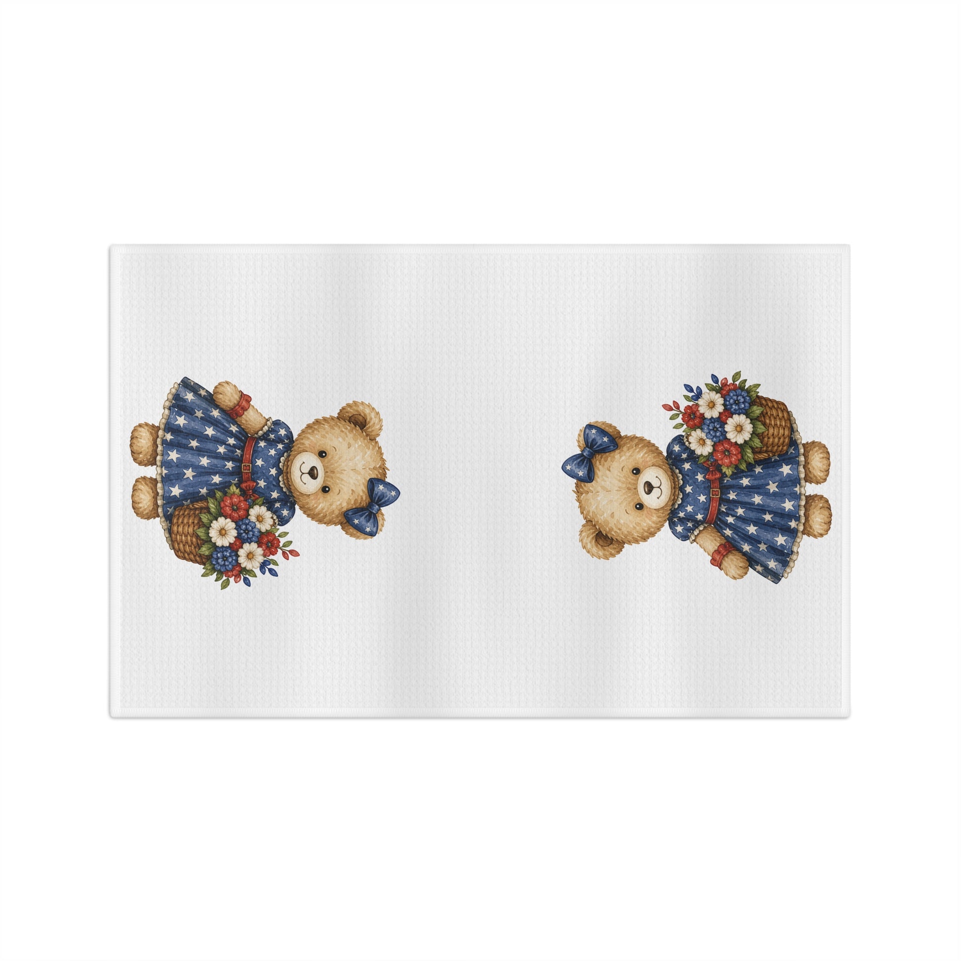 White microfiber tea towel with two teddy bears in star-dotted navy dresses holding red, white, and blue floral baskets.