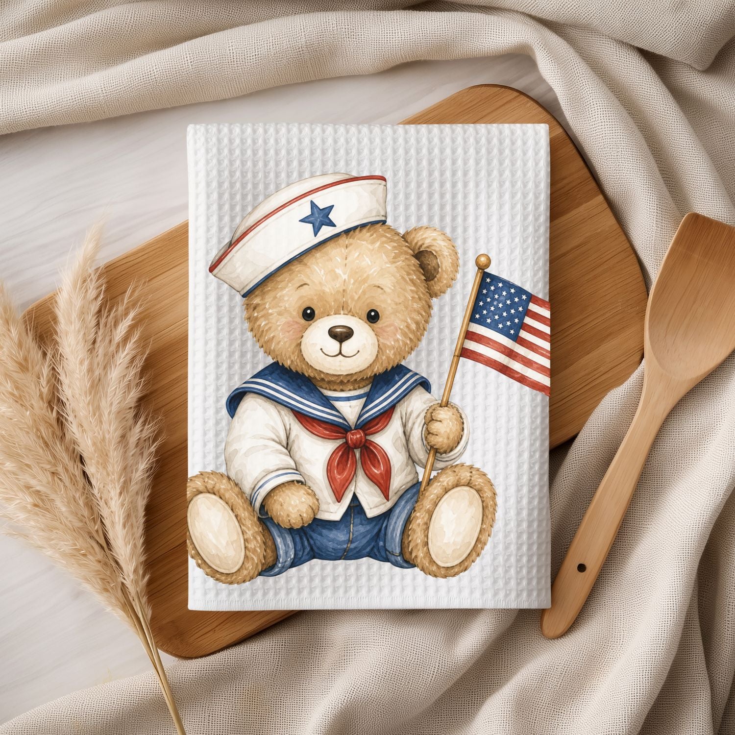 White microfiber tea towel with a patriotic teddy bear sailor holding an American flag.
