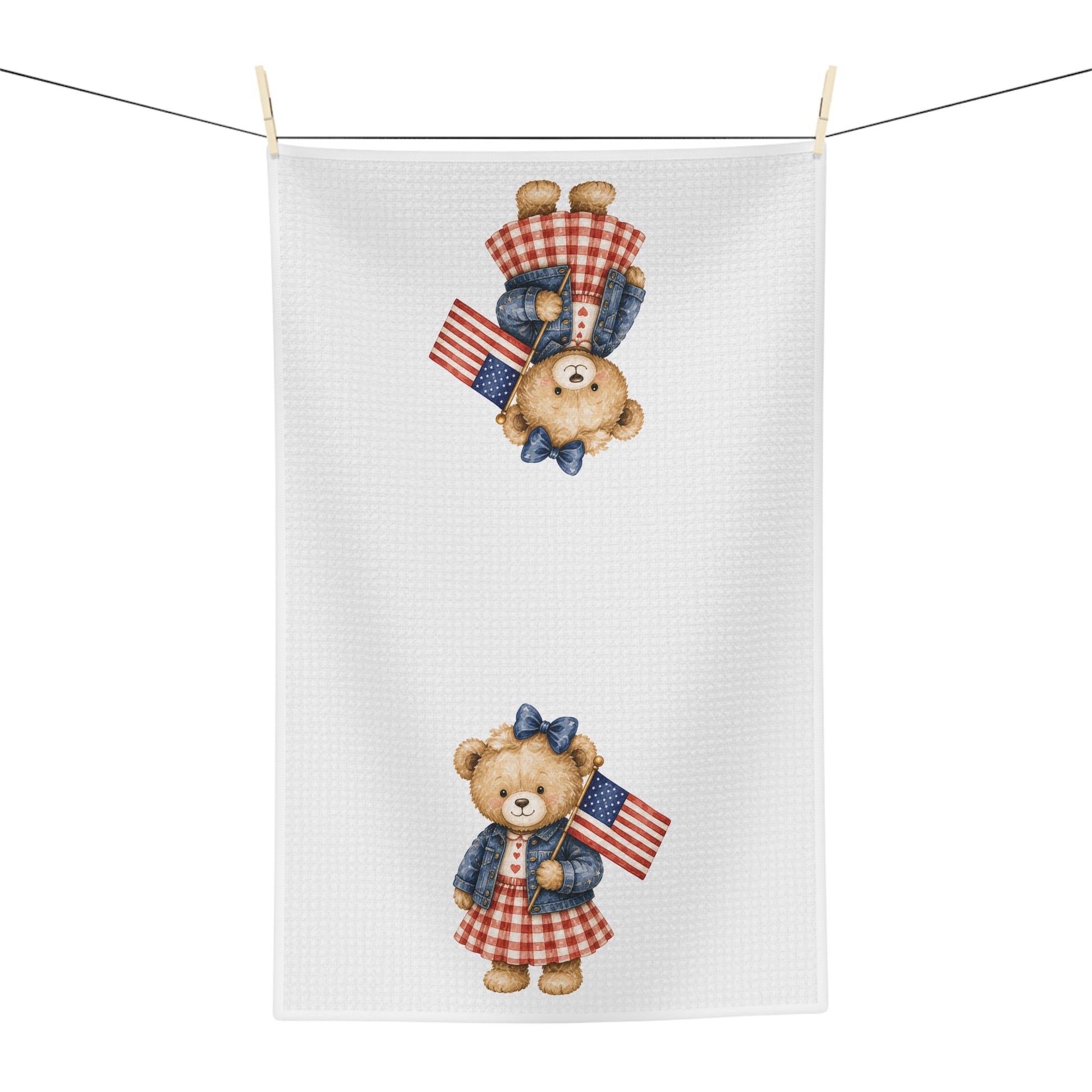 White microfiber tea towel with two teddy bears in gingham dresses holding American flags.