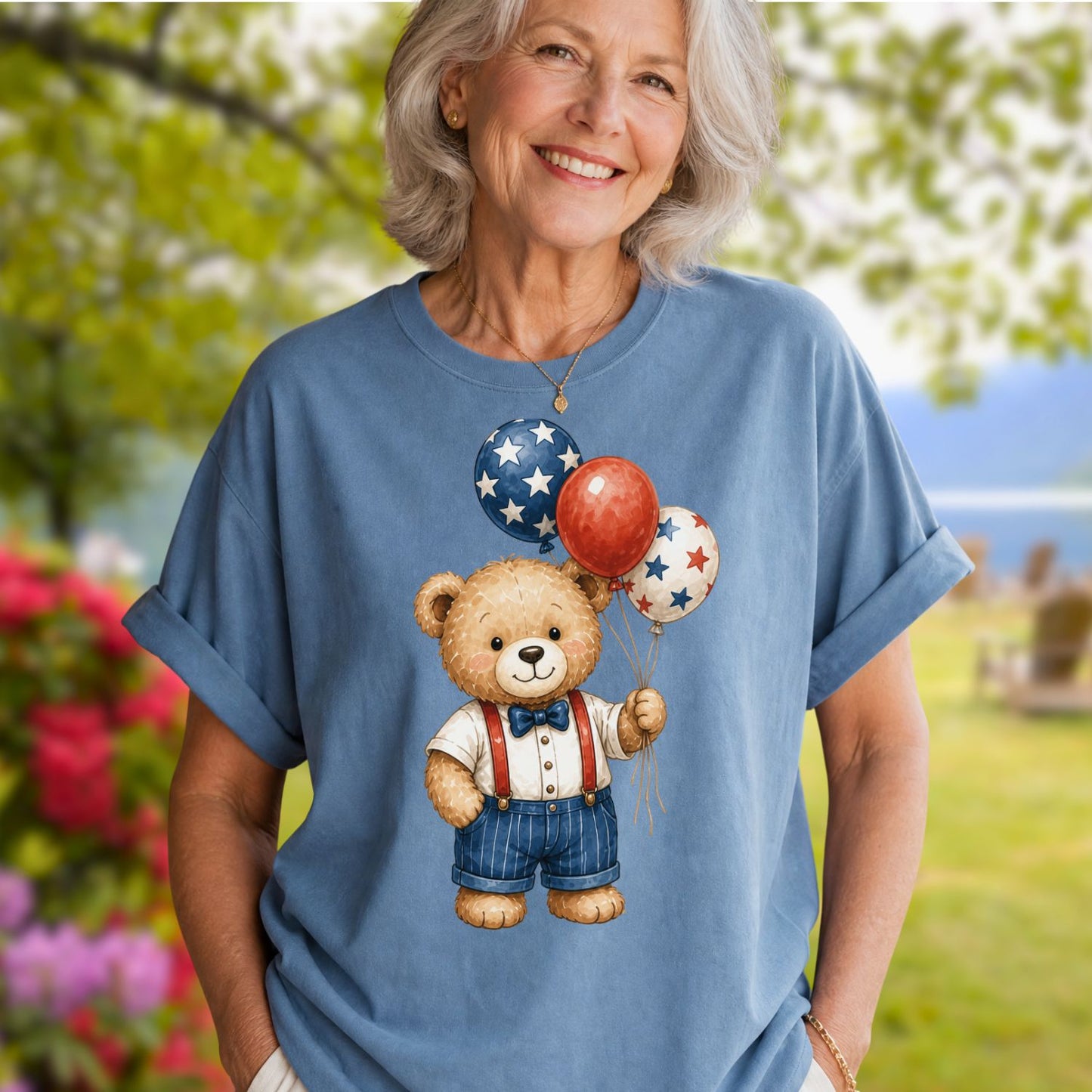 Woman in a relaxed-fit, garment-dyed blue t-shirt with a vintage teddy bear holding star balloons.