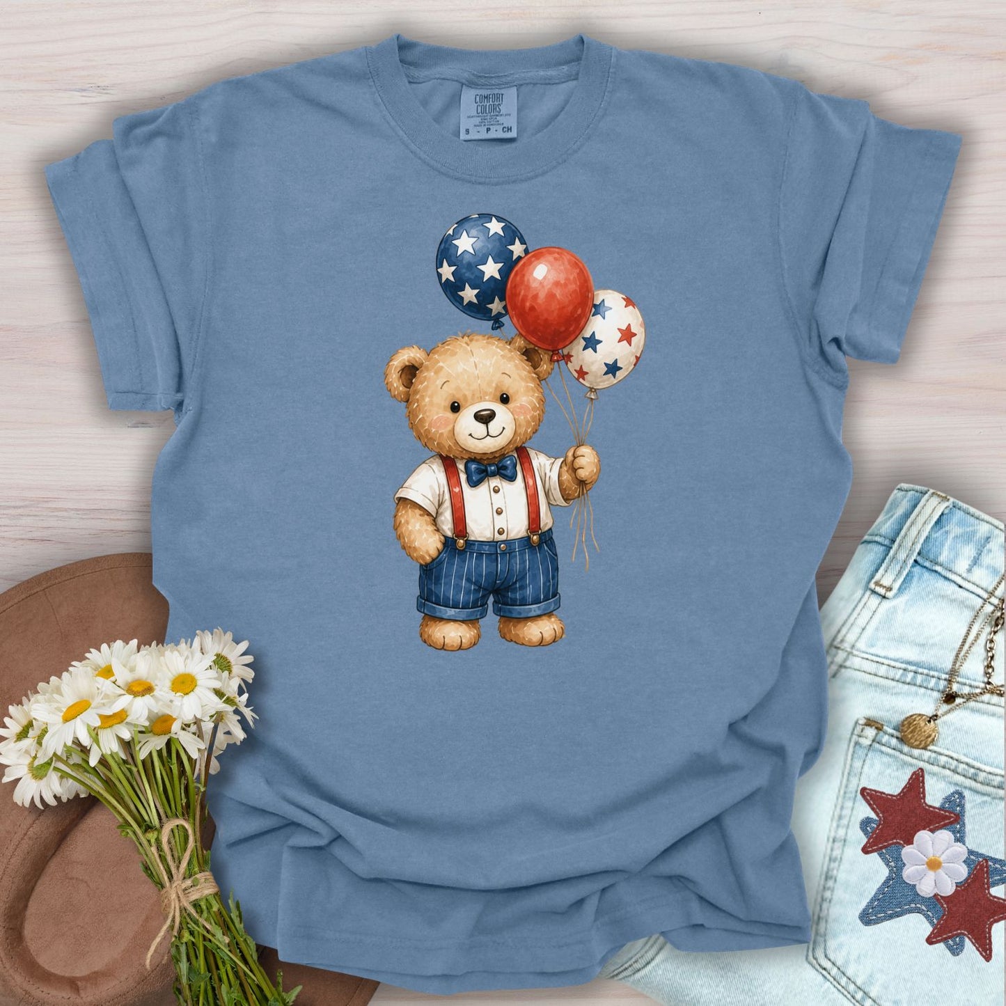 Blue Jean S t-shirt with a vintage teddy bear holding red, white, and blue star balloons.
