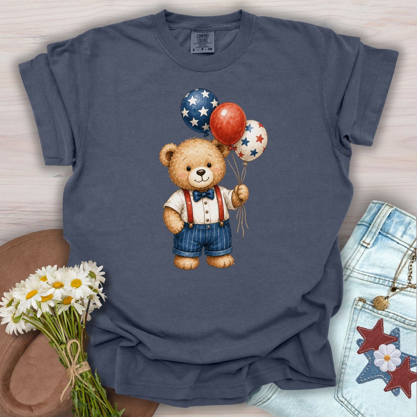 Denim S t-shirt with a vintage teddy bear holding red, white, and blue star balloons.