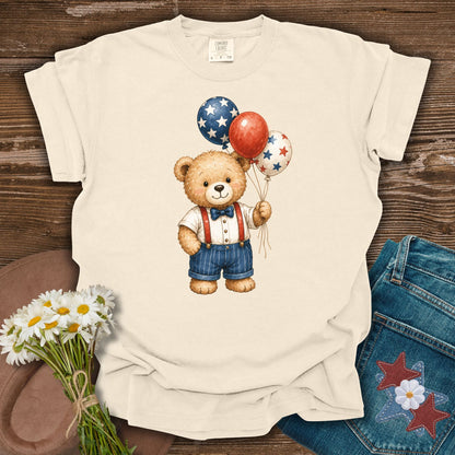 Ivory S t-shirt with a vintage teddy bear holding red, white, and blue star balloons.