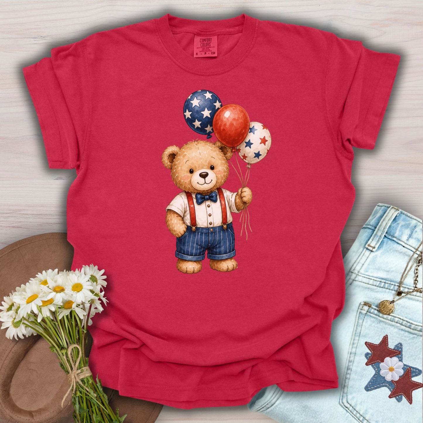 Red S-sized cotton tee with a vintage teddy bear holding patriotic star balloons.